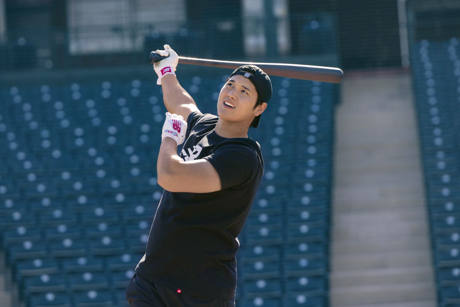 Shohei Ohtani swings a baseball bat.